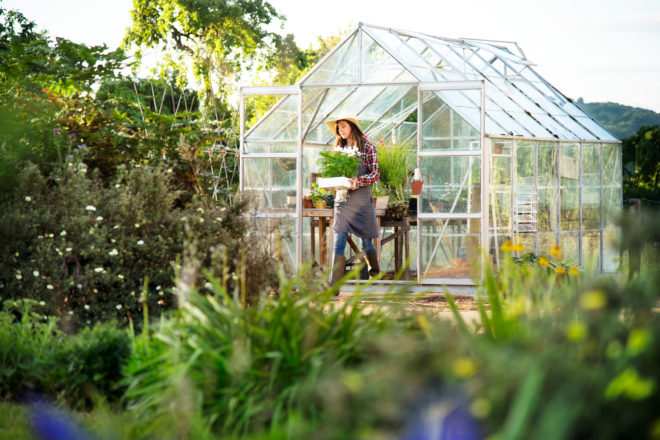 Woman walking from her greenhouse