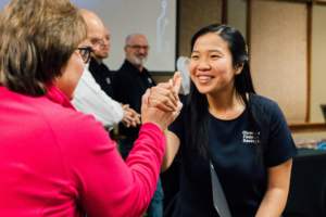 Gift Arruk receiving an award at the OlyFed Employee Appreciation event.